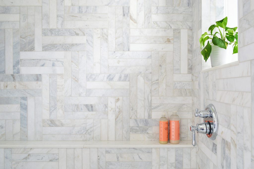 Detail of Herringbone Marble Tile Shower With Shampoo Ledge