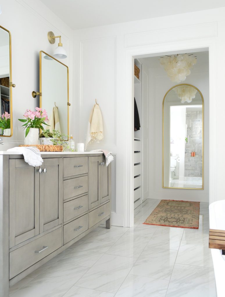 Marlbe bathroom with gray double vanity and doorway into walk in closet