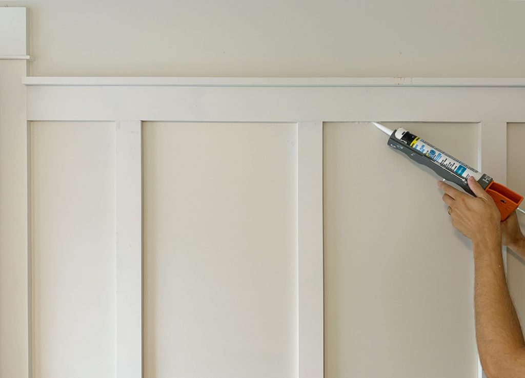 Applying Caulk Bead To Seams On Board And Batten Installation