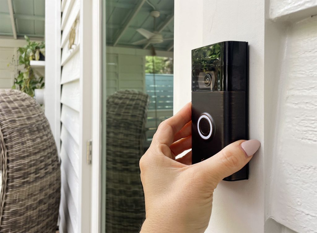 Hand Placing Ring Video Doorbell Onto Mount