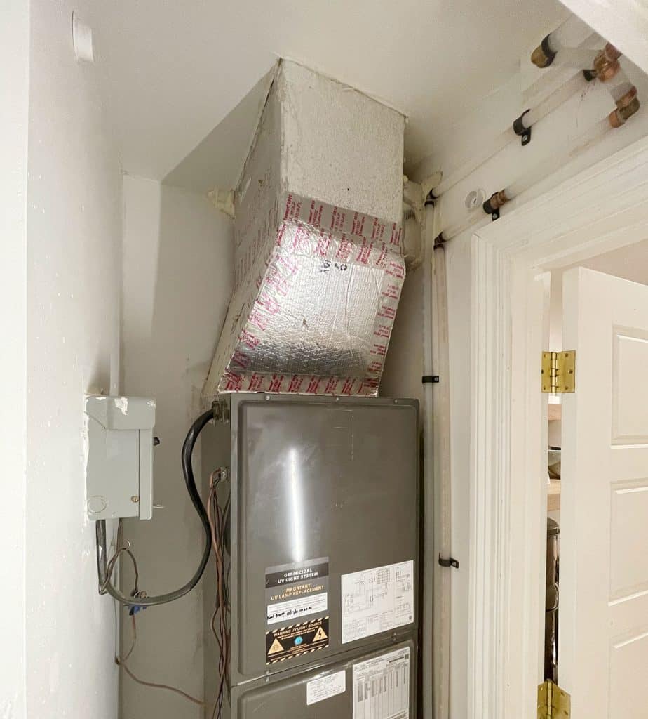 View of inside of closet with clean plumbing pipes running behind door molding