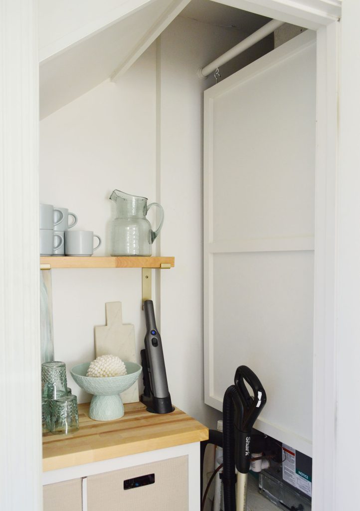 Wood Cover Panel Hanging In Utility Closet To Hide HVAC Unit