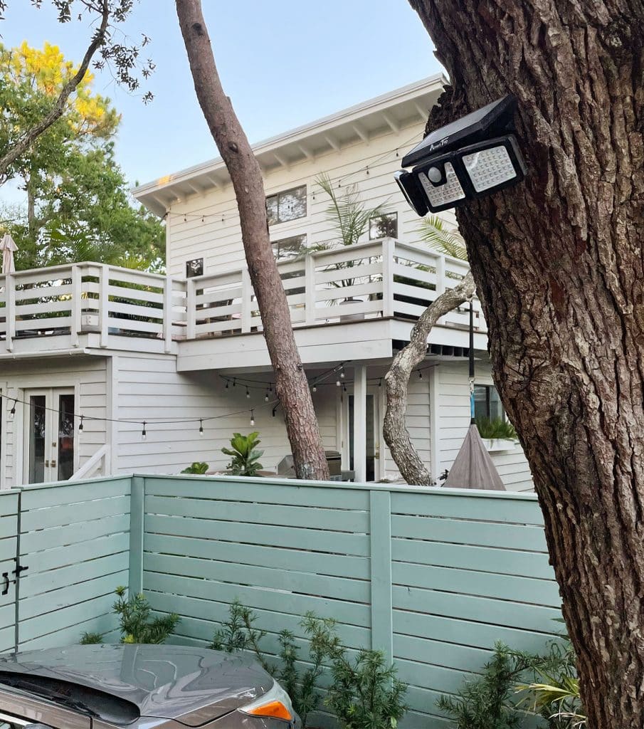 Solar powered flood light mounted above parking area