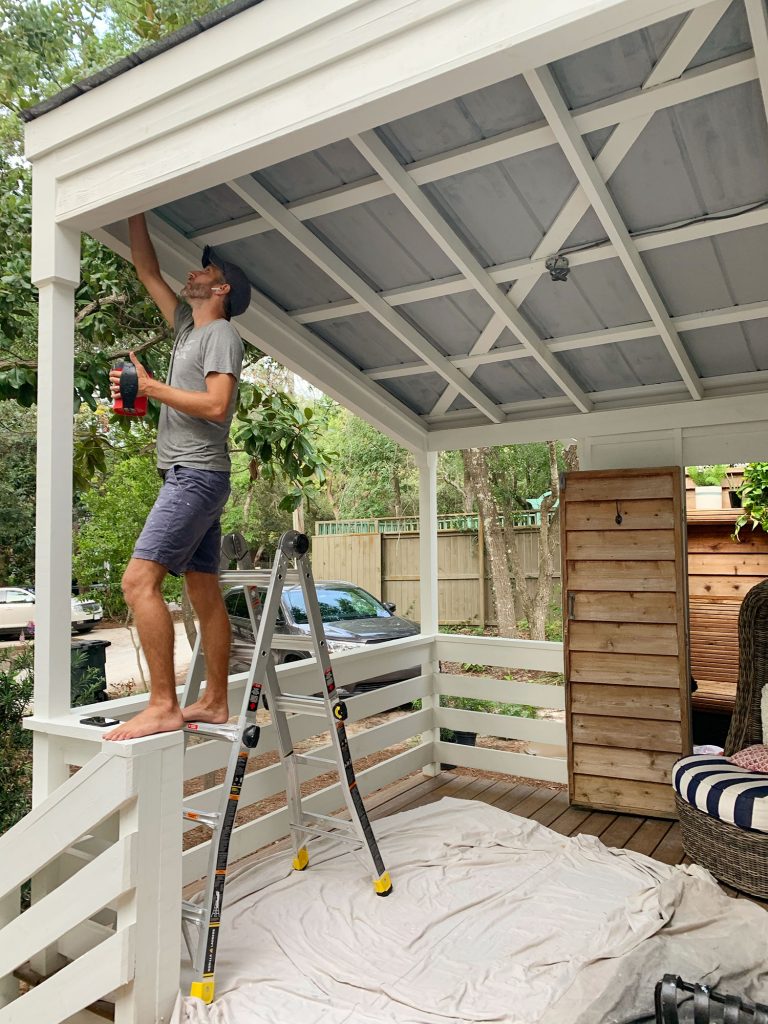 John Standing On Ladder Priming Metal Porch Ceiling