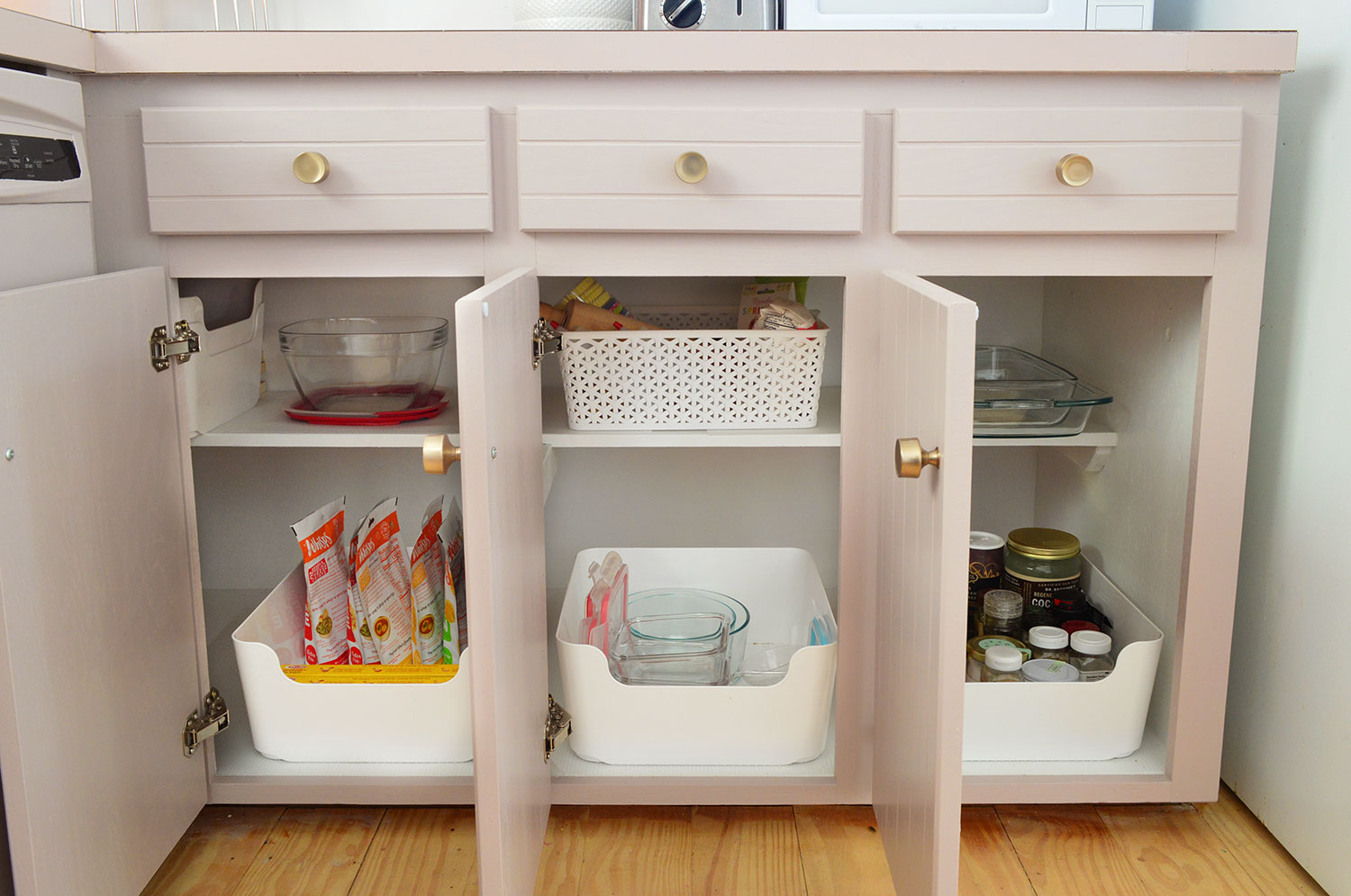 Three Lower Cabinet Opened To Show Narrow Storage Capabilities