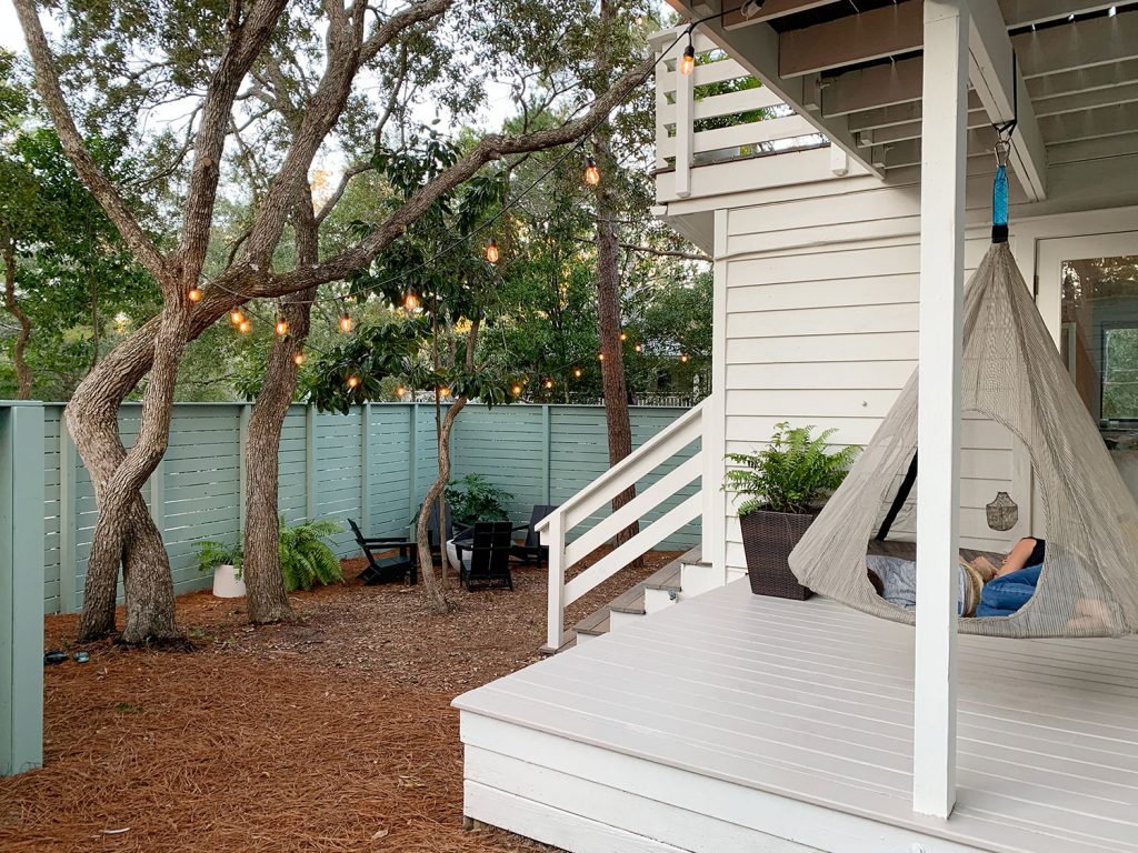 View of side yard and covered side porch with hanging tent swing