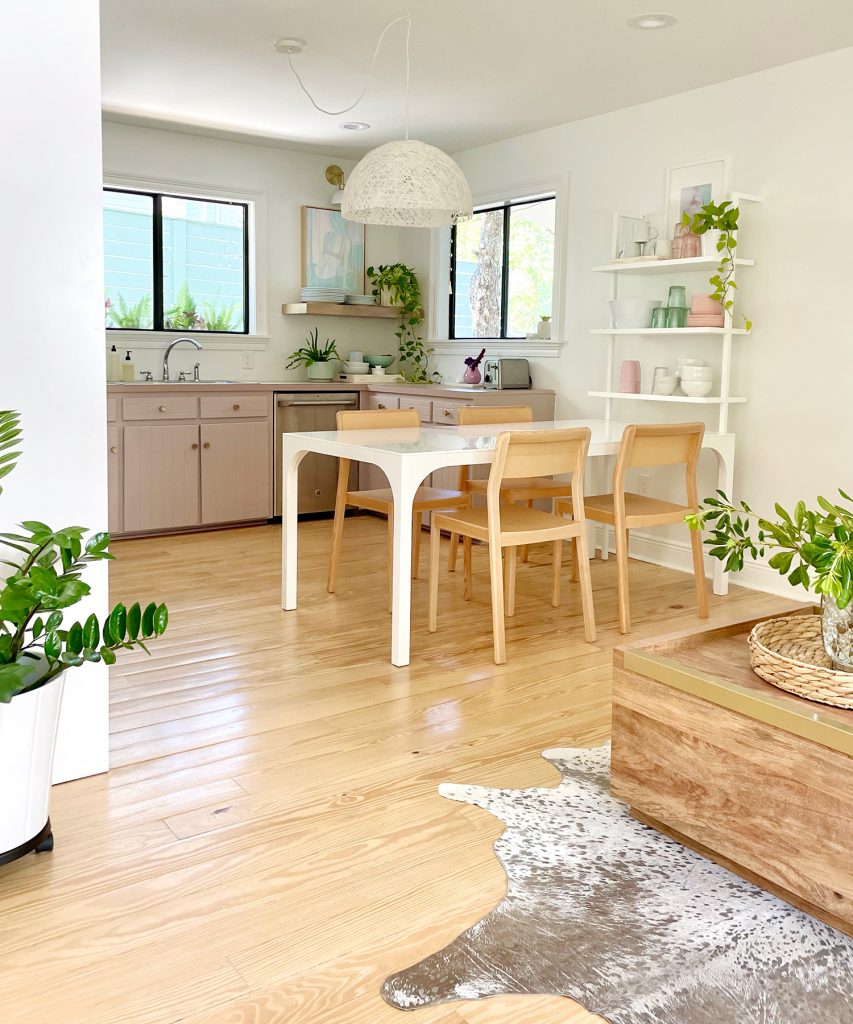 Vertical View Of Walking Space To Beachy Kitchen With Wood Furniture And Mauve Cabinets