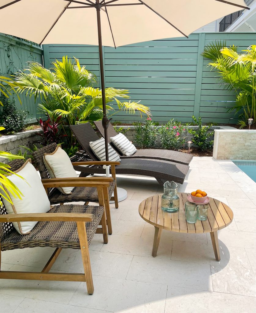 Sideview of seating area with umbrella lounge chairs and small coffee table