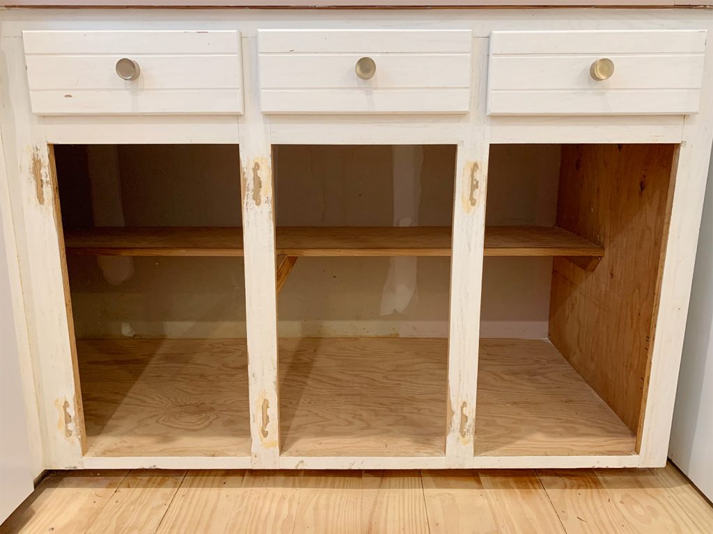 Three lower cabinet frames sanded and holes filled with wood filler