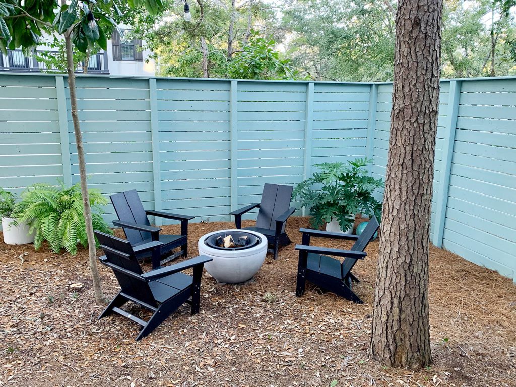 Side yard with blue-green painted horizontal fence